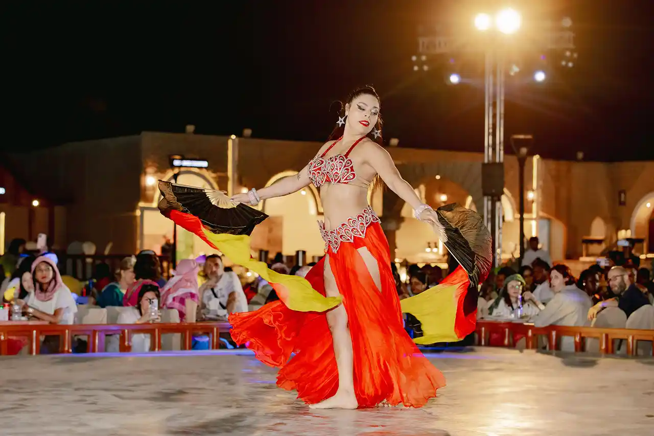 Traditional belly dance performance entertaining guests at a Dubai desert safari camp