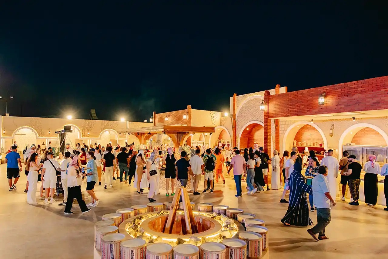 Guests enjoying BBQ dinner under the evening sky during a desert safari in Dubai