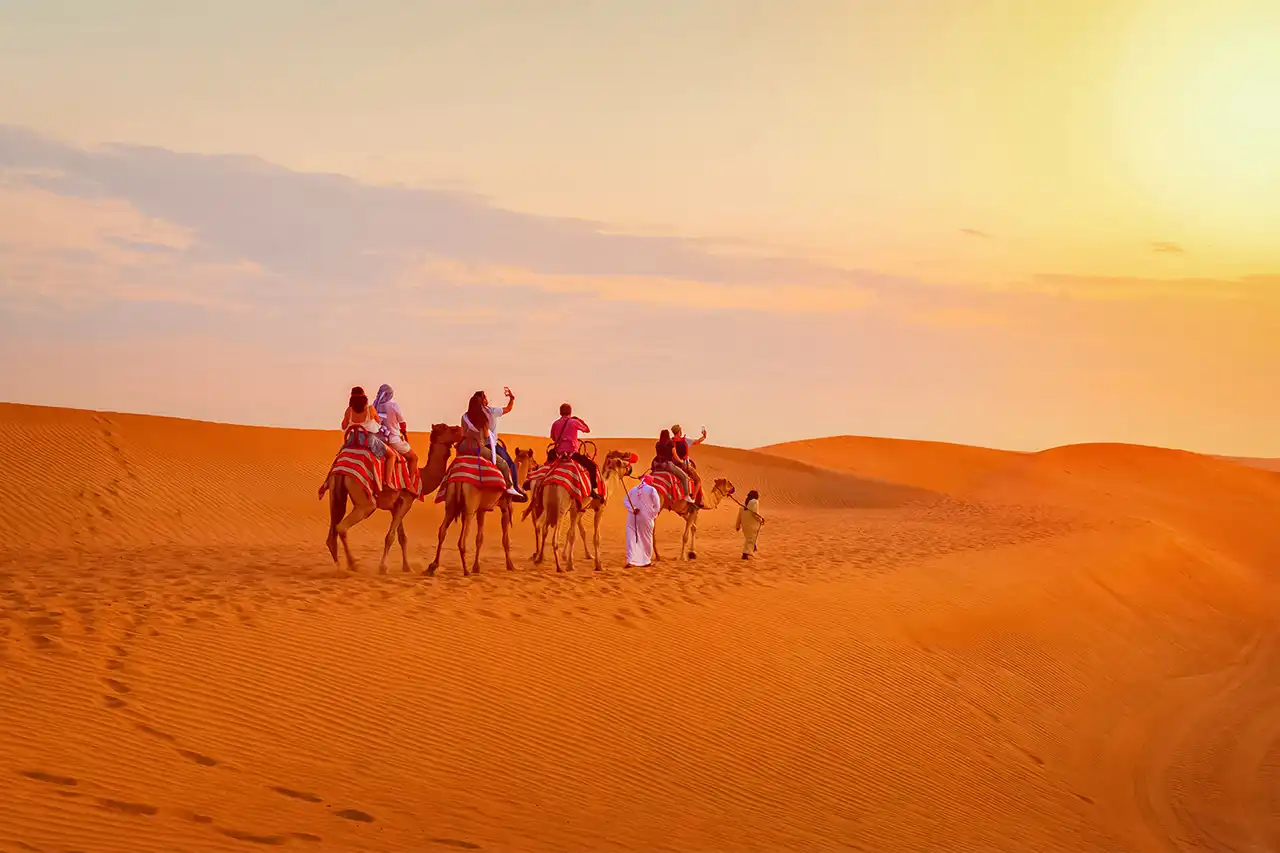 Camel ride through the golden Dubai desert during a peaceful evening safari experience