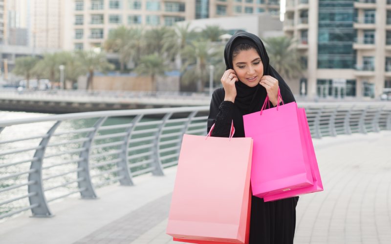 Arab woman carrying shopping bags in Dubai.