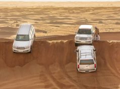 3 White color SUV on the sand at Dubai Desert Safari.