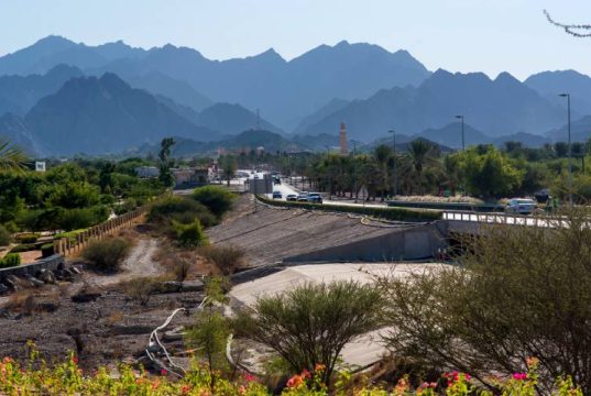 Beautiful Hatta lake with mountains in the background .