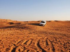 A white color Suv in Dubai desert safari.