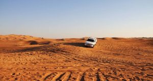 A white color Suv in Dubai desert safari.